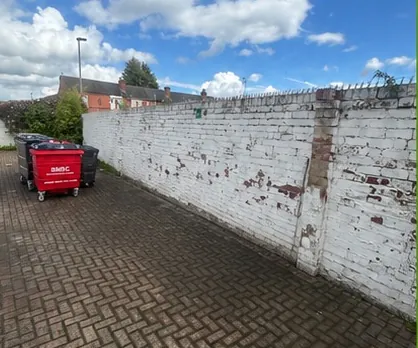 The same cobbled back street cleared with only the bin left in place