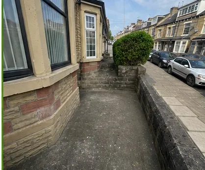 The same front garden cleared, showing a clean path back to the bay window