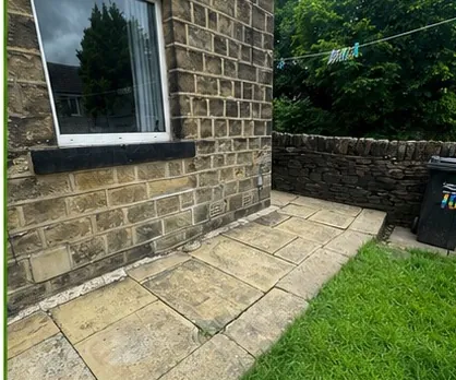 The same paved area empty and swept after the furniture was removed