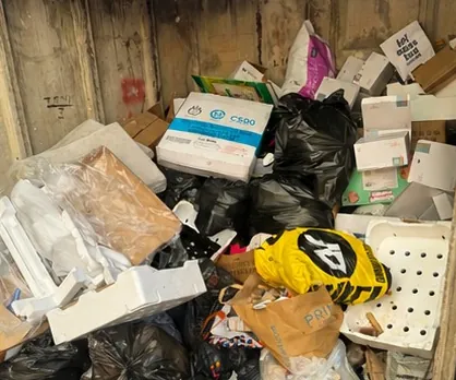 Garage packed to the doors with boxes, timber and household clutter