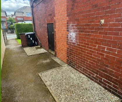 The same alleyway cleared of timber with the brick wall fully visible
